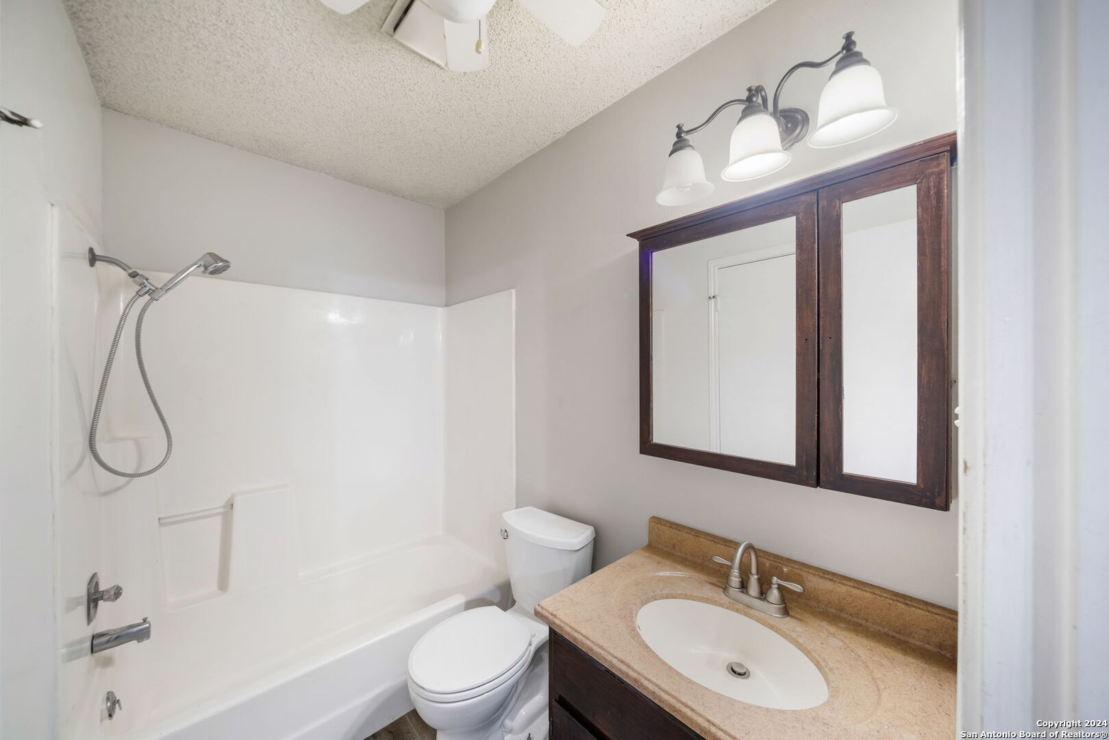 12106 Ridge Ct Street San Antonio, TX 78247 - Photo 18 of 25 a bathroom with a granite countertop sink toilet a mirror and shower