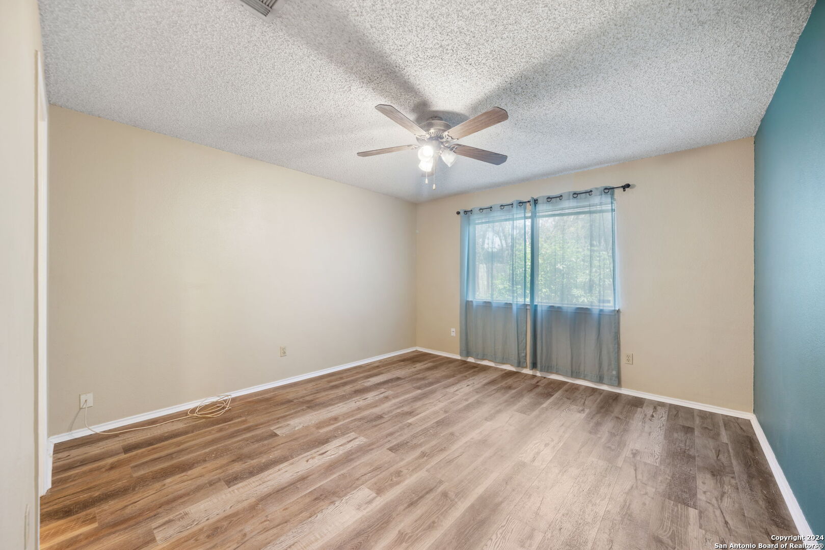 12106 Ridge Ct Street San Antonio, TX 78247 - Photo 19 of 25 wooden floor in an empty room with a window