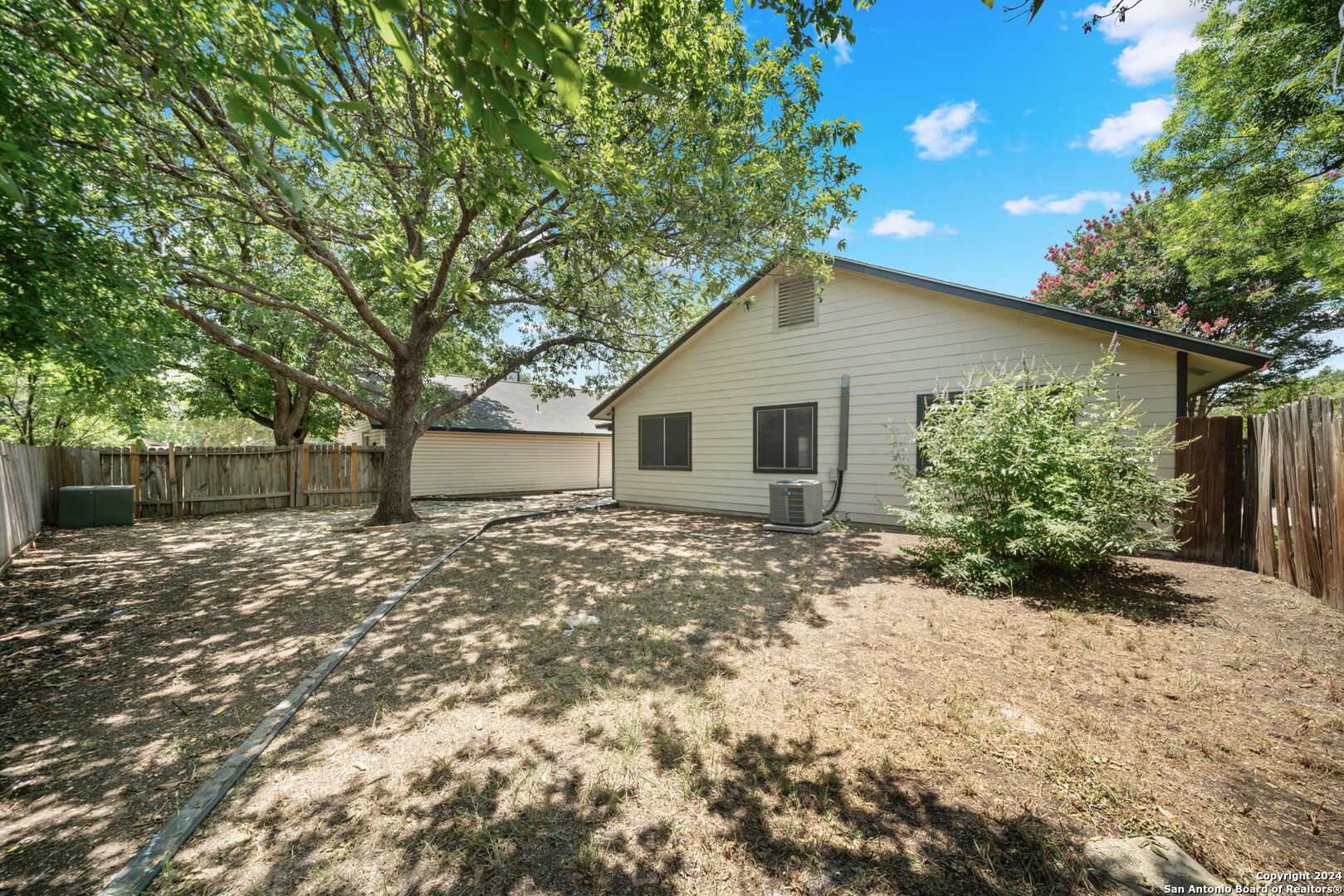 12106 Ridge Ct Street San Antonio, TX 78247 - Photo 24 of 25 a view of a house with a yard and large tree