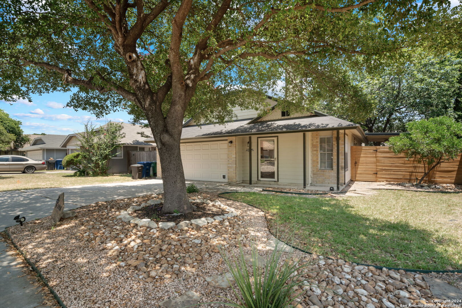 12106 Ridge Ct Street San Antonio, TX 78247 - Photo 6 of 25 a front view of a house with a yard and garage