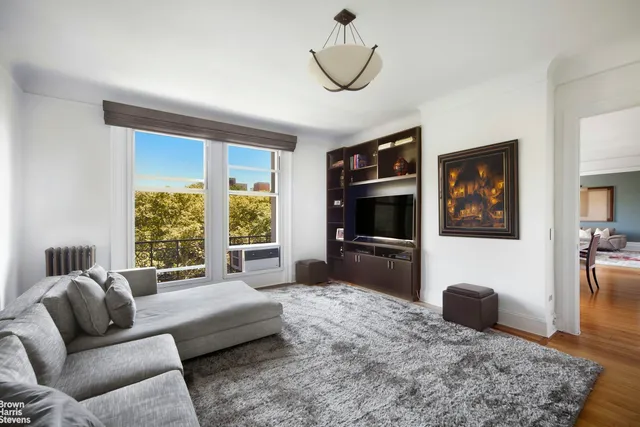 a living room with furniture window and a flat screen tv