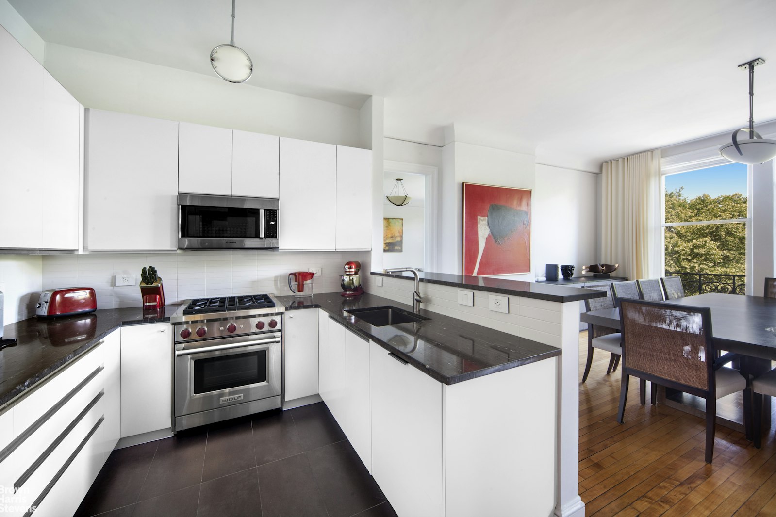 100 West 80th Street, Unit 6B Manhattan, NY 10024 - Photo 6 of 12 a kitchen with stainless steel appliances granite countertop a stove a sink and a microwave