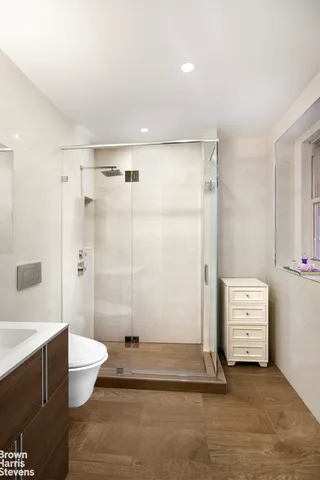 a bathroom with a shower a toilet and a sink