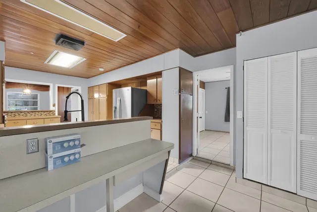 a hallway with sliding door and chandelier