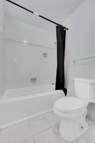 a bathroom with a toilet and a bathtub