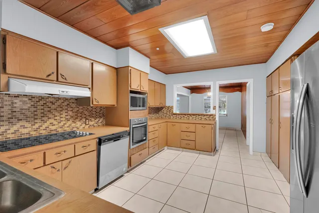 a kitchen with a stove a sink and a refrigerator