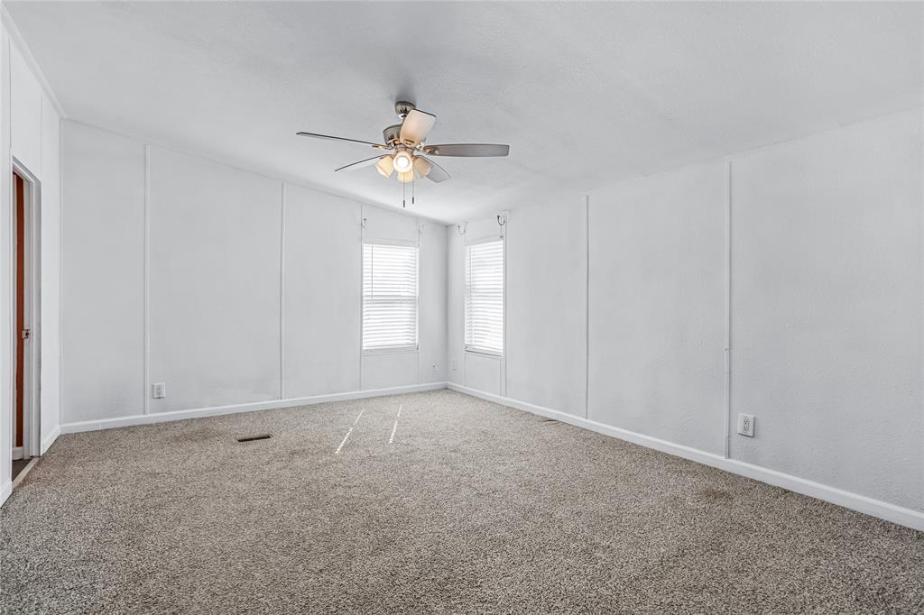 112 Pine Ridge Circle Southmayd, TX 75092 - Photo 11 of 25 an empty room with windows and chandelier fan
