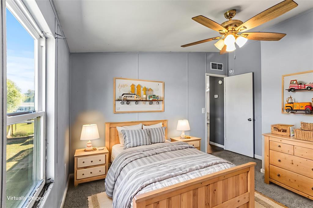 112 Pine Ridge Circle Southmayd, TX 75092 - Photo 14 of 25 a bedroom with a bed and a chandelier