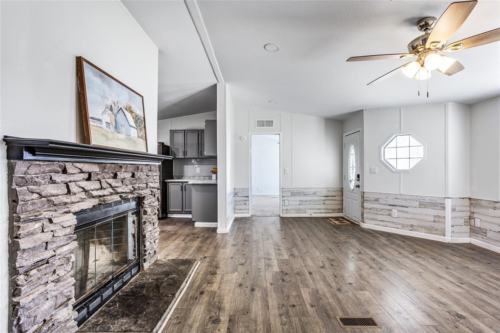 112 Pine Ridge Circle Southmayd, TX 75092 - Photo 7 of 25 an empty room with wooden floor fireplace and windows