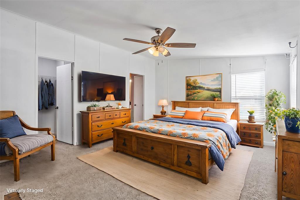 112 Pine Ridge Circle Southmayd, TX 75092 - Photo 9 of 25 a bedroom with a bed and a chandelier