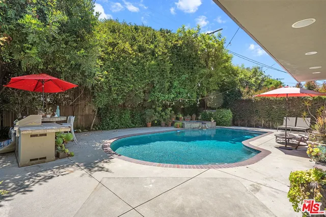 a view of a backyard with a patio and fire pit