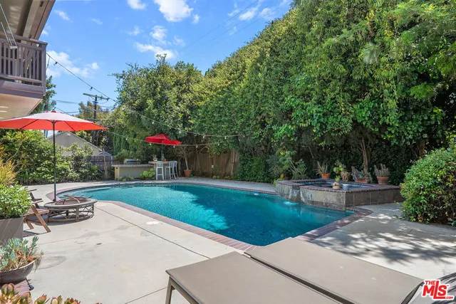 a view of a backyard with sitting area