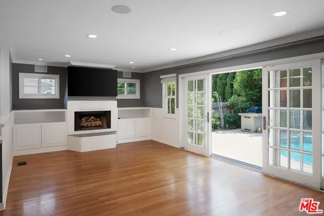 a view of a livingroom with an empty space and a fireplace