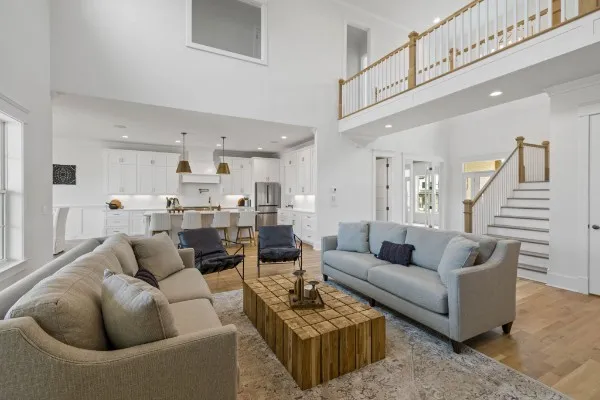 a kitchen with stainless steel appliances a dining table chairs and a refrigerator