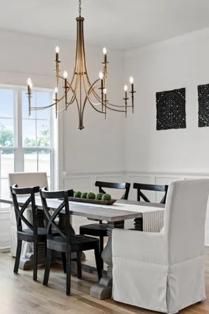 a dining room with furniture a chandelier and wooden floor