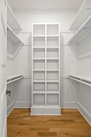 a view of a white house with a yard patio and swimming pool