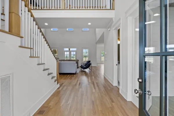 a view of entryway and hall with wooden floor