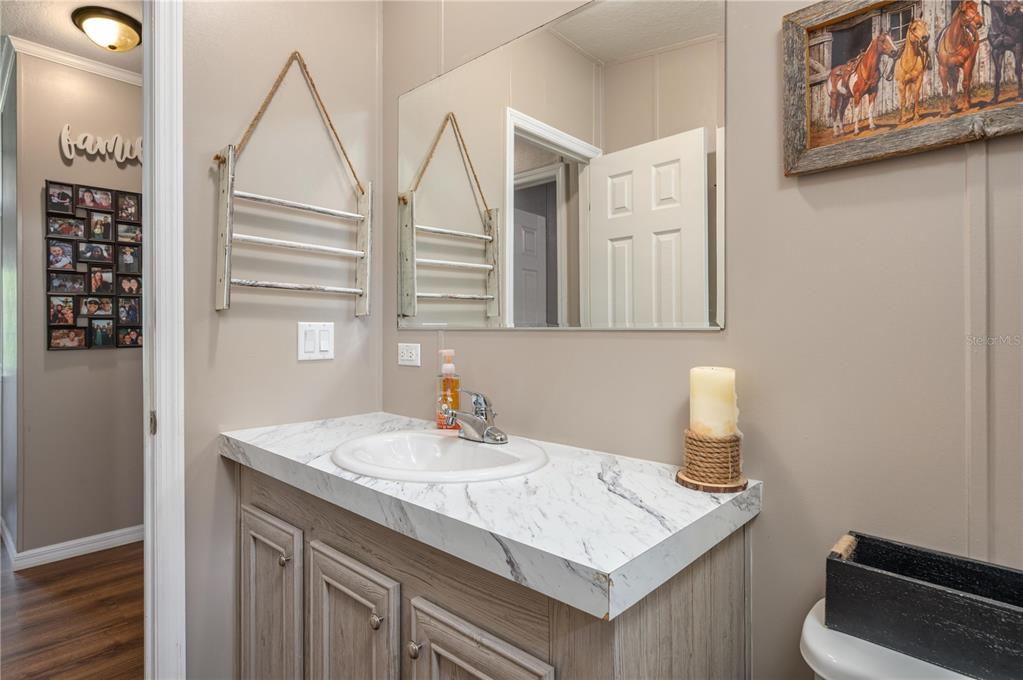 15079 Brahma Road Polk City, FL 33868 - Photo 27 of 40 a bathroom with a sink a vanity and a mirror