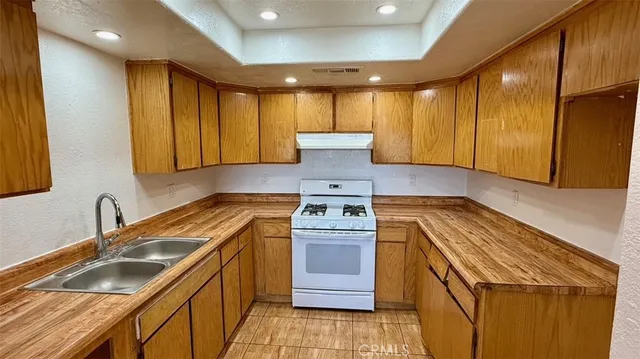 a kitchen with a sink stove and cabinets