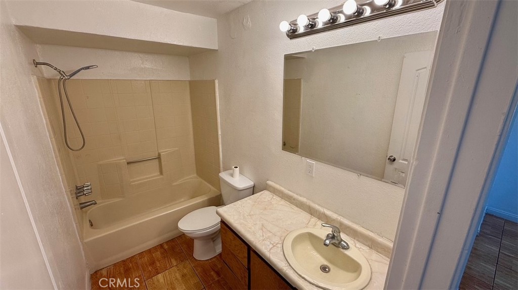 16026 K Street Mojave, CA 93501 - Photo 8 of 10 a bathroom with a granite countertop sink toilet and shower