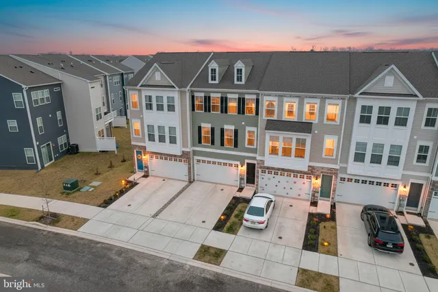 a front view of a residential apartment building with a yard