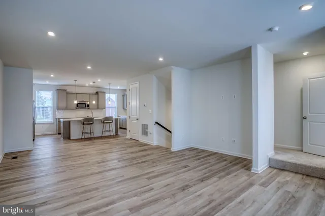 a open kitchen with white cabinets and stainless steel appliances