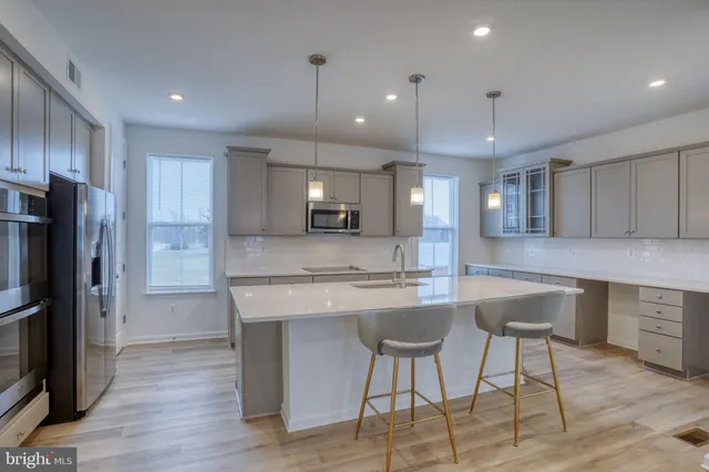 a kitchen with kitchen island a sink and stainless steel appliances