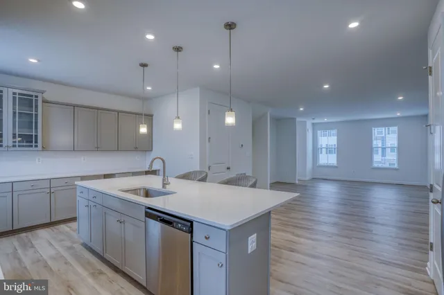 a kitchen with a sink a microwave a stove and cabinets