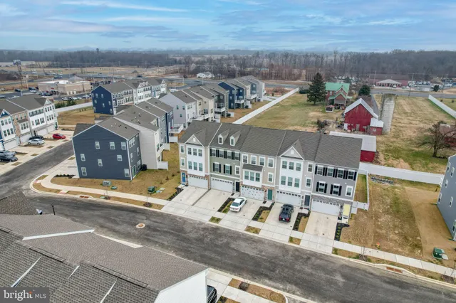 an aerial view of residential houses with outdoor space