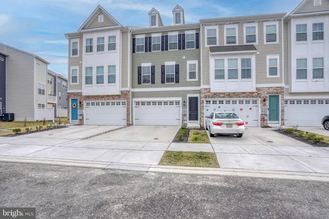a front view of a building with a yard and a garage