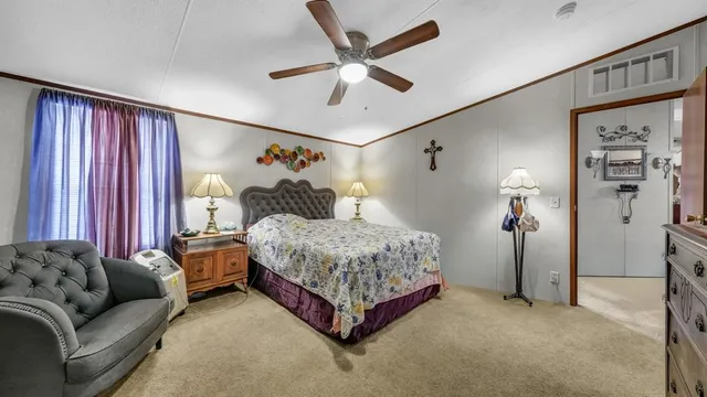 a bedroom with a bed couch and window