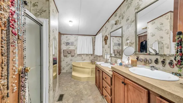 a bathroom with a double vanity sink mirror and toilet