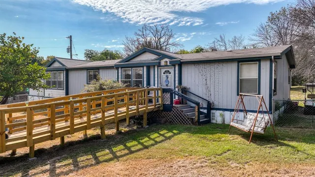 a view of a house with a wooden deck
