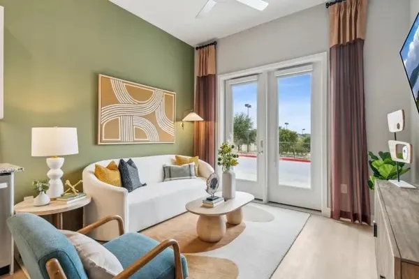 a living room with furniture and a potted plant