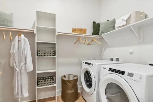 a view of washer and dryer with kitchen in the background