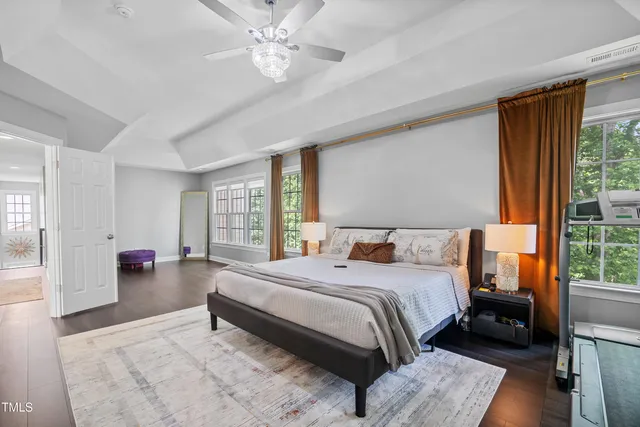 a living room with furniture a fireplace and a large window