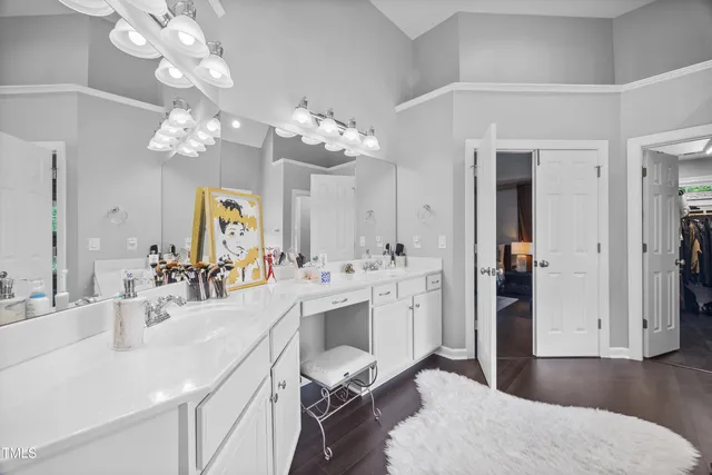 a bathroom with a sink toilet and a mirror