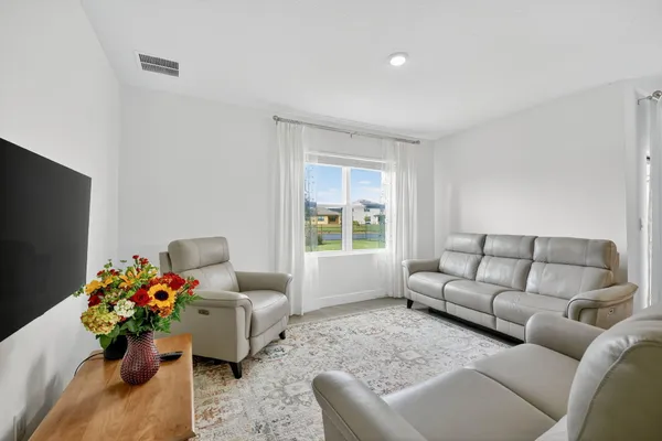 a living room with furniture and a large window