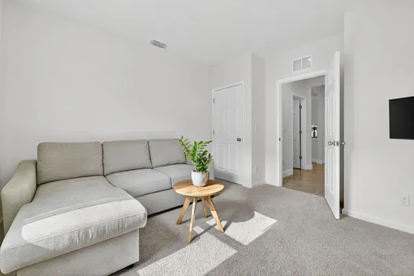 a living room with a couch and a dining table