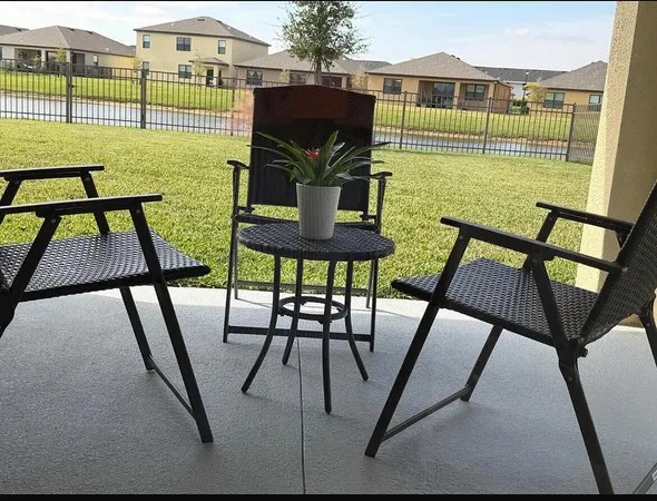 a view of a chairs and table in the patio