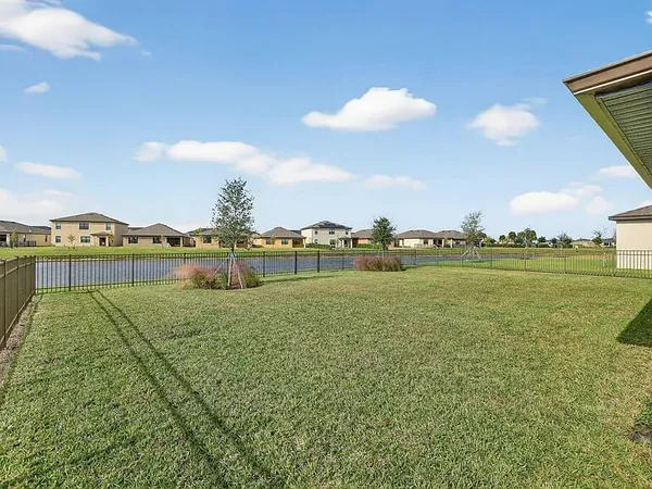 a view of a lake with houses in the back