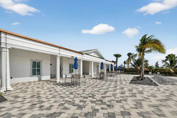 a row of palm trees in front of house