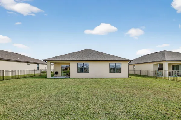 a view of a house with a yard and porch