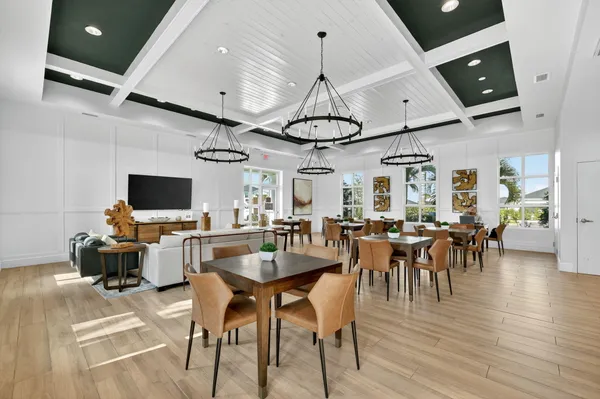 a view of a dining room with furniture wooden floor and chandelier