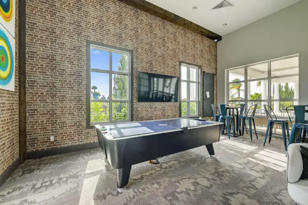 a living room with furniture a flat screen tv and kitchen view