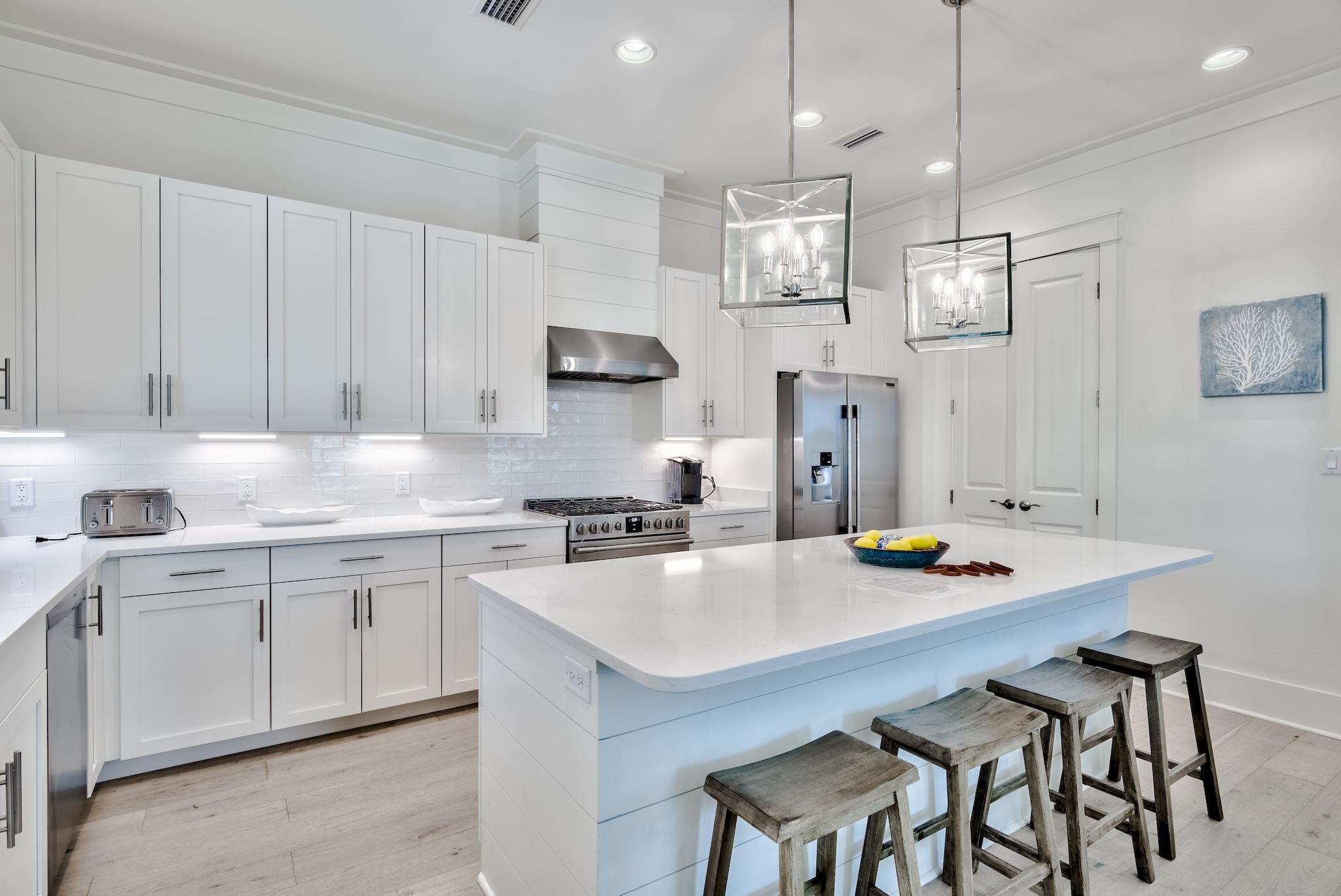 196 Redbud Ln Inlet Beach Inlet Beach, FL 32461 - Photo 12 of 49 a kitchen with stainless steel appliances a table chairs sink and stove top oven