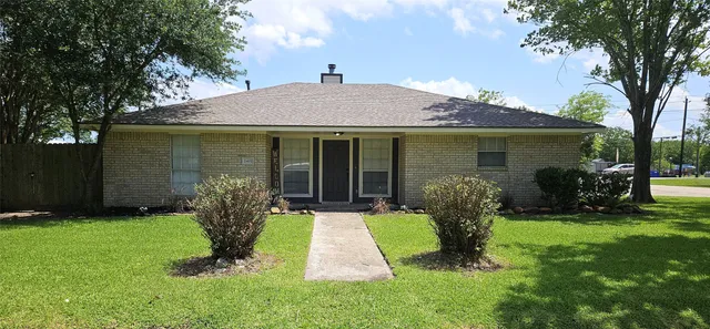 a front view of a house with a yard and porch