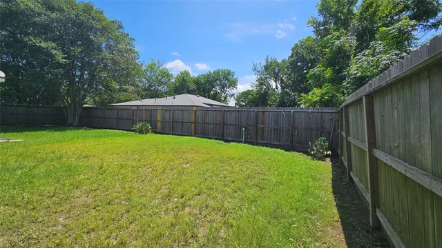 a view of a backyard with a small cabin and a chair