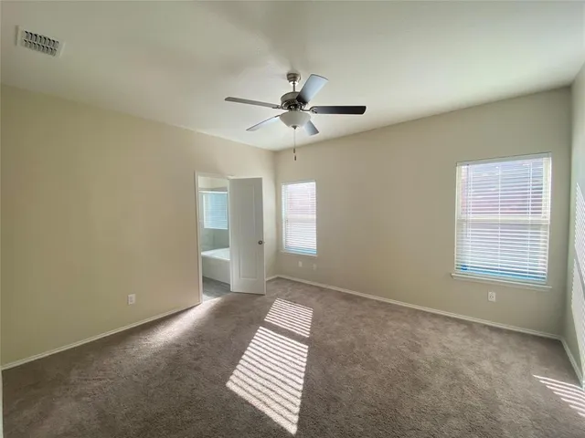 a kitchen with a refrigerator sink and cabinets