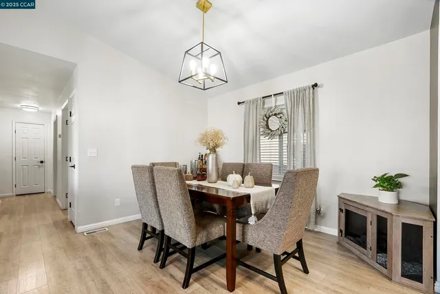a view of a dining room with furniture wooden floor and chandelier